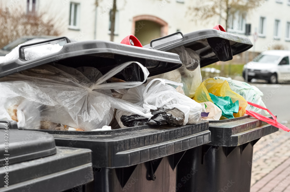 View of garbage containers with trash in city, closeup