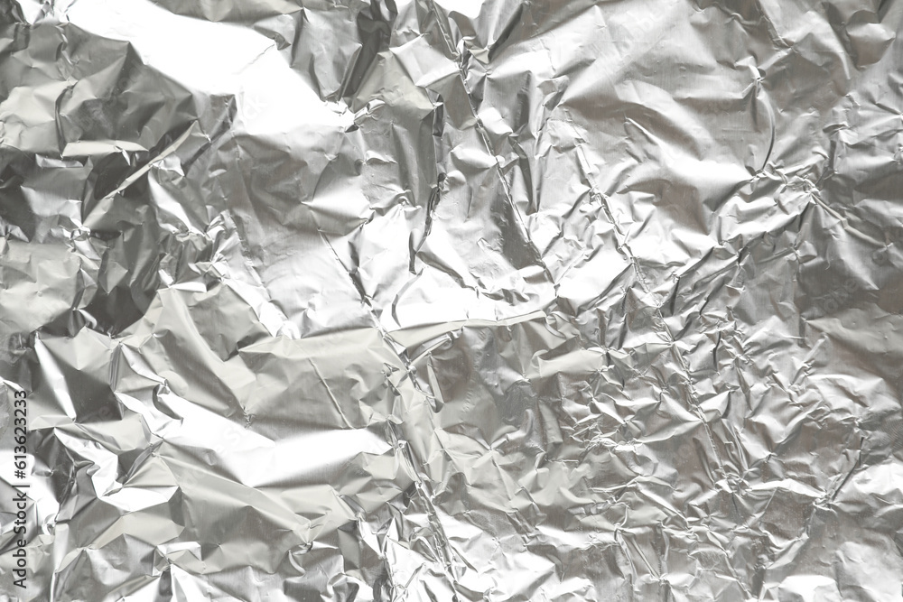 Crumpled sheet of aluminium foil as background, closeup