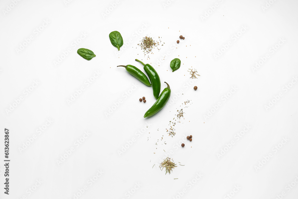 Composition with fresh chili peppers and spices on light background