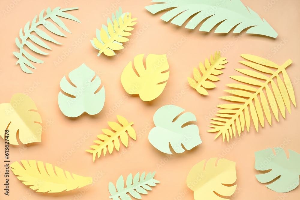 Paper tropical leaves on orange background