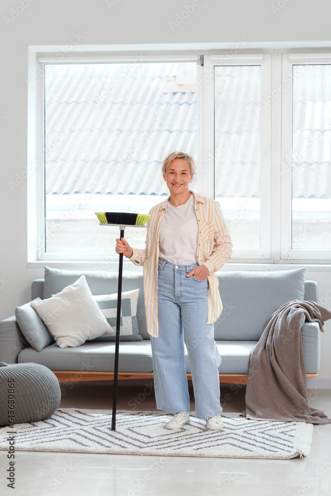 Mature woman with floor brush in room