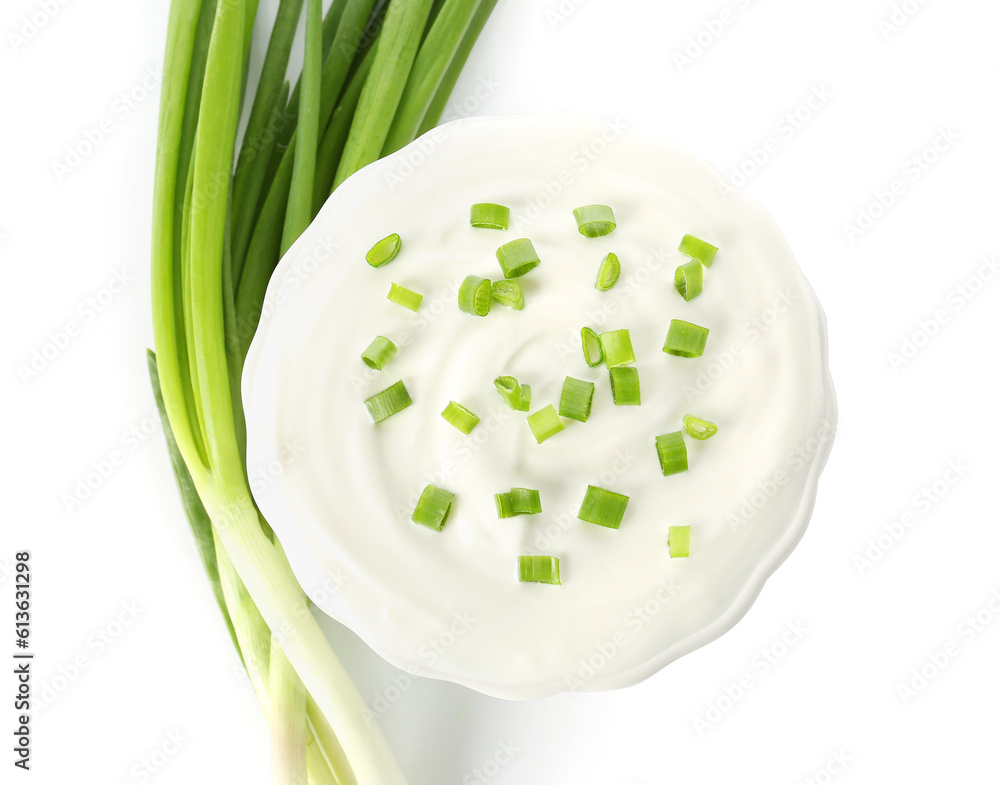 Bowl of tasty sour cream with green onion on white background