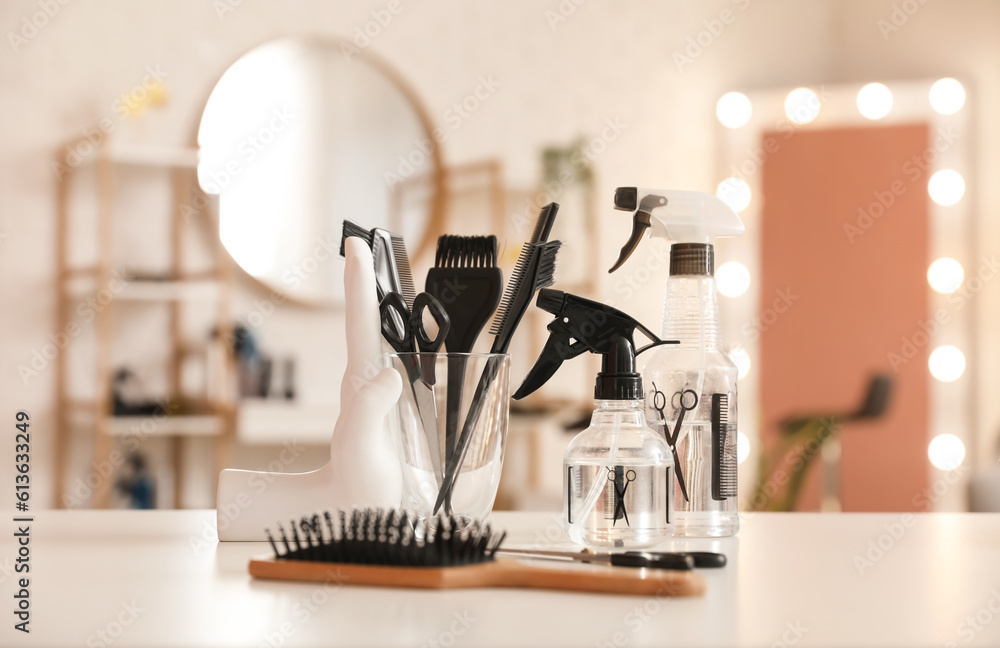 Different hairdressing tools on table in beauty salon