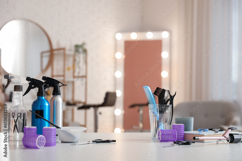 Different hairdressing tools on table in beauty salon