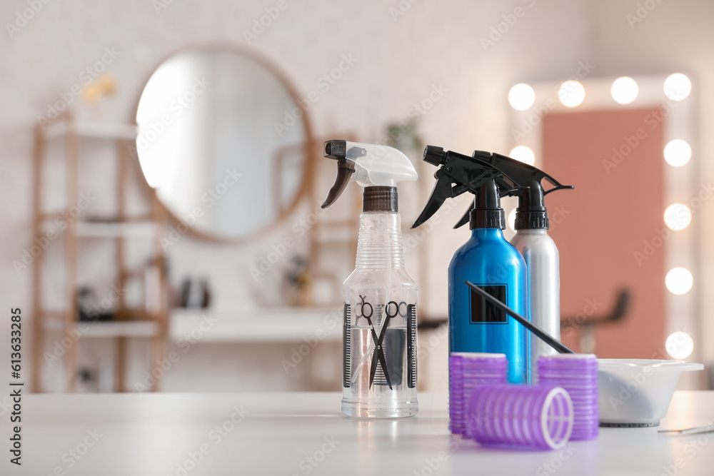 Different hairdressing tools on table in beauty salon