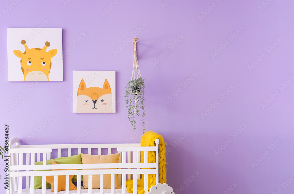 Stylish interior of childrens room with baby bed and paintings