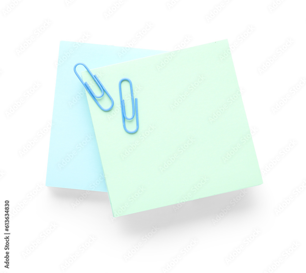 Sticky note with paper clip on white background