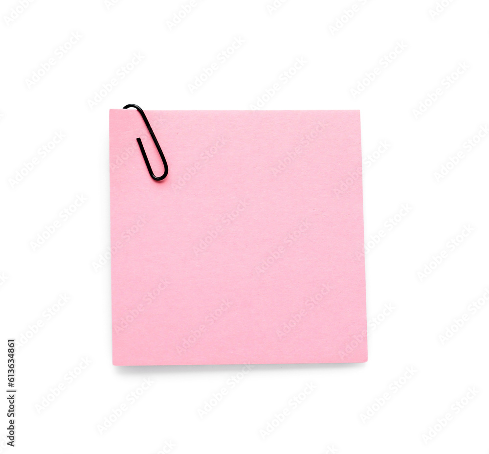 Pink sticky note with paper clip on white background