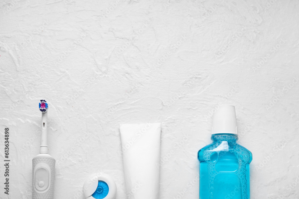 Set for oral hygiene on textured white background