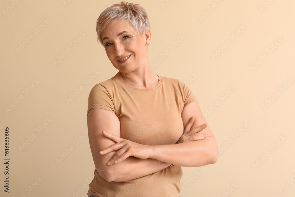 Mature blonde woman on beige background