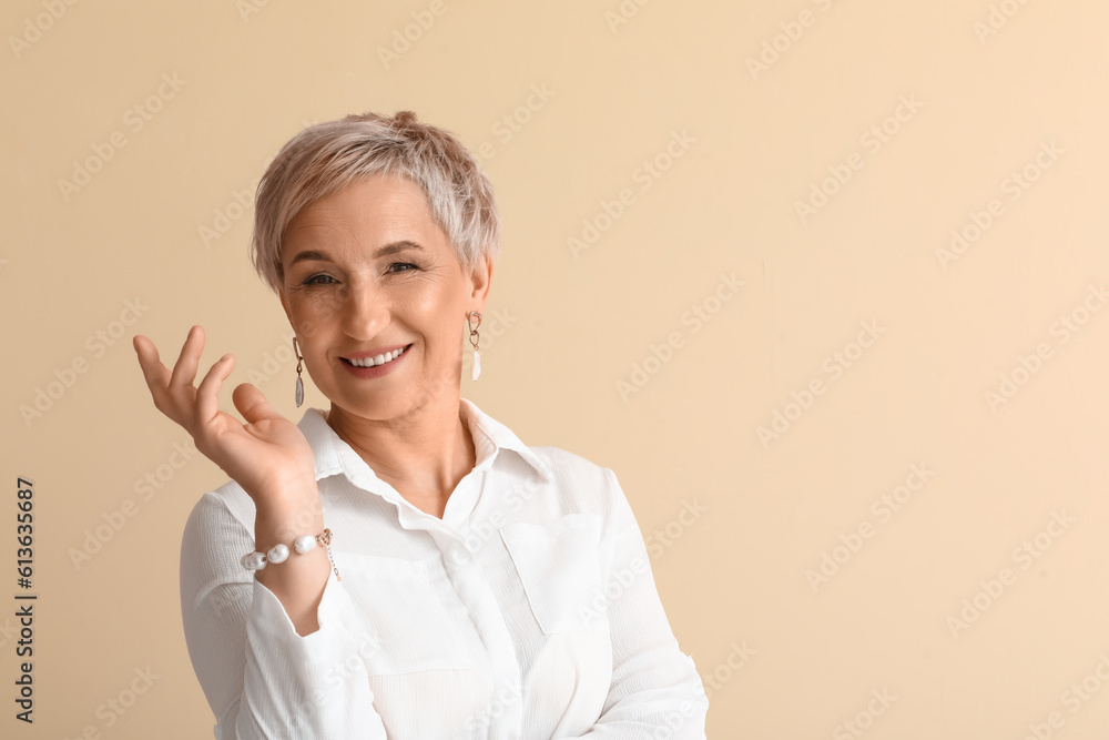 Mature blonde woman on beige background