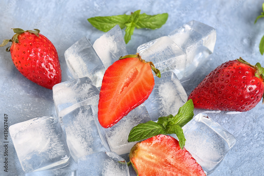 Fresh strawberry with ice cubes on blue background