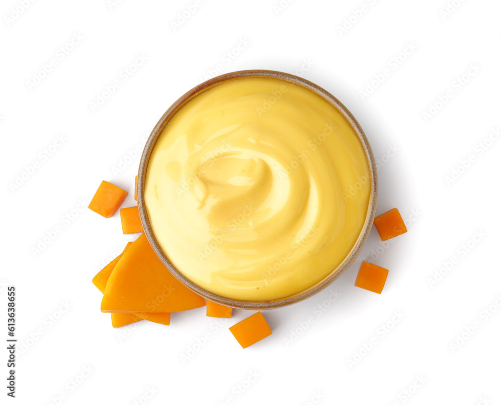 Bowl of tasty cheddar sauce with cheese slices on white background