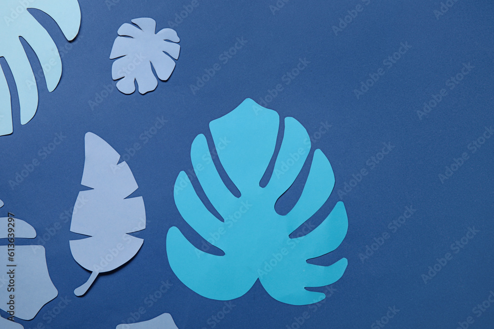 Beautiful origami leaves on blue background