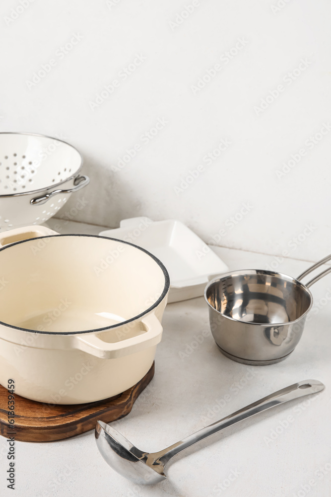 Set of different kitchen utensils on light background