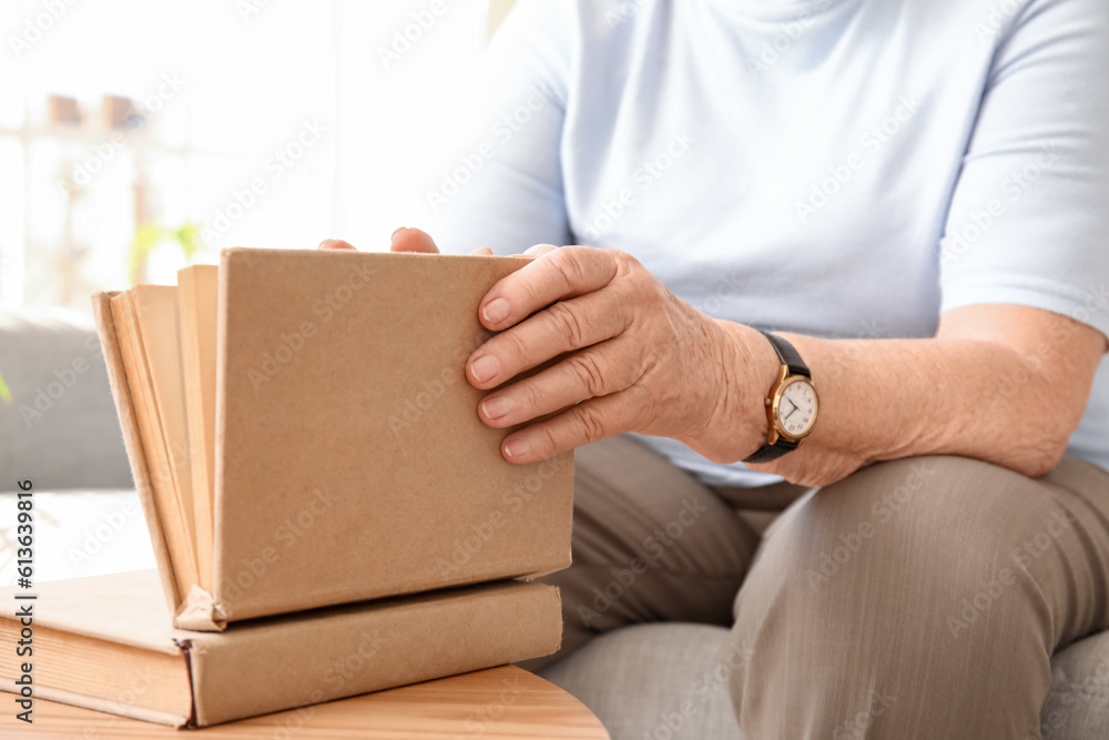 Senior woman with book at home, closeup