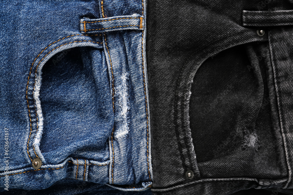 Different folded jeans as background, closeup