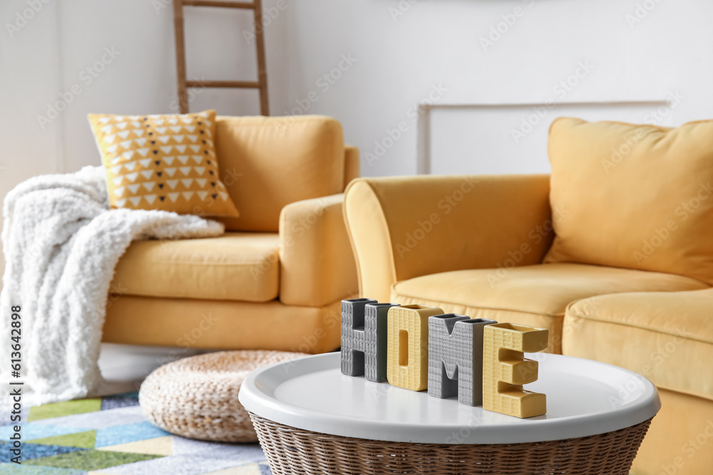 Decor in shape of word HOME on table in living room, closeup