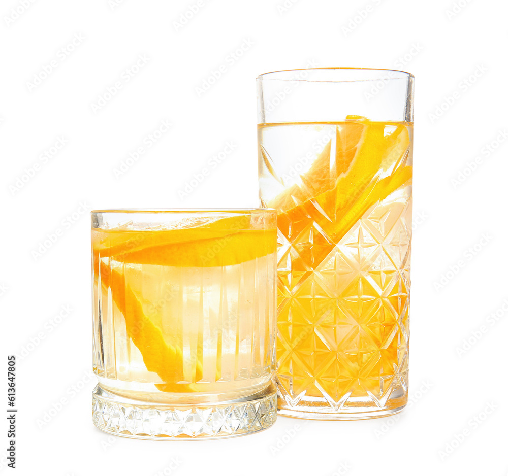 Glasses of infused water with orange slices on white background