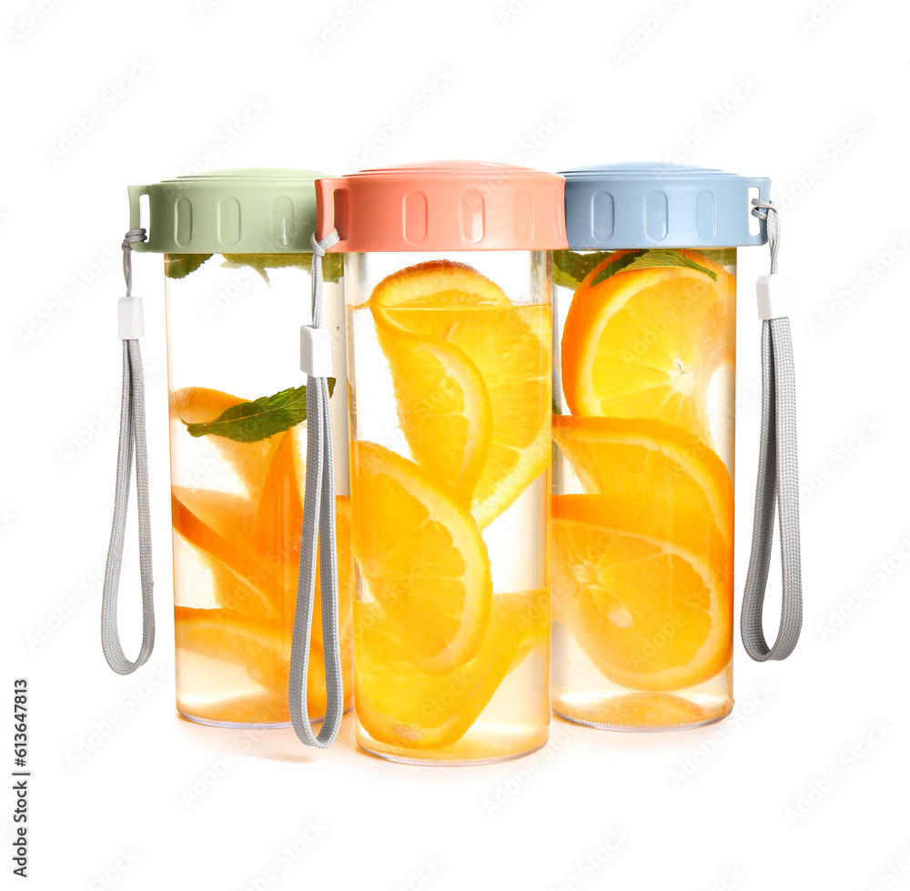 Sports bottles of infused water with orange slices on white background