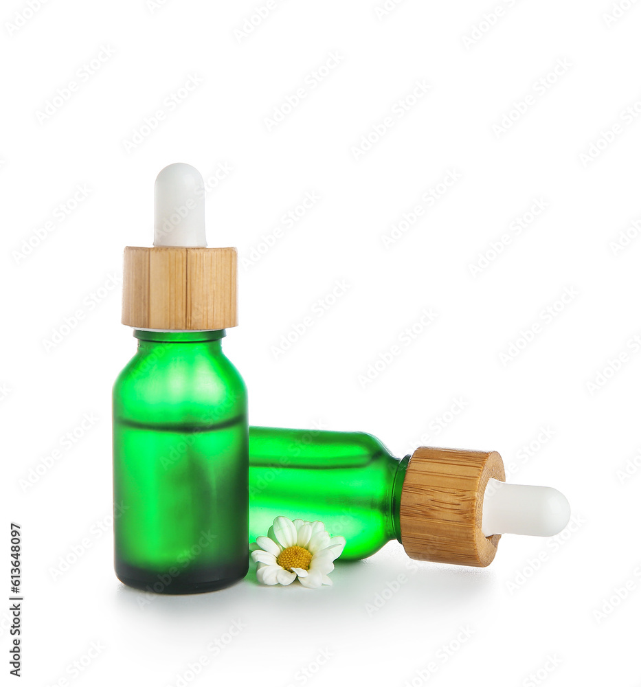 Bottles of chamomile essential oil isolated on white background