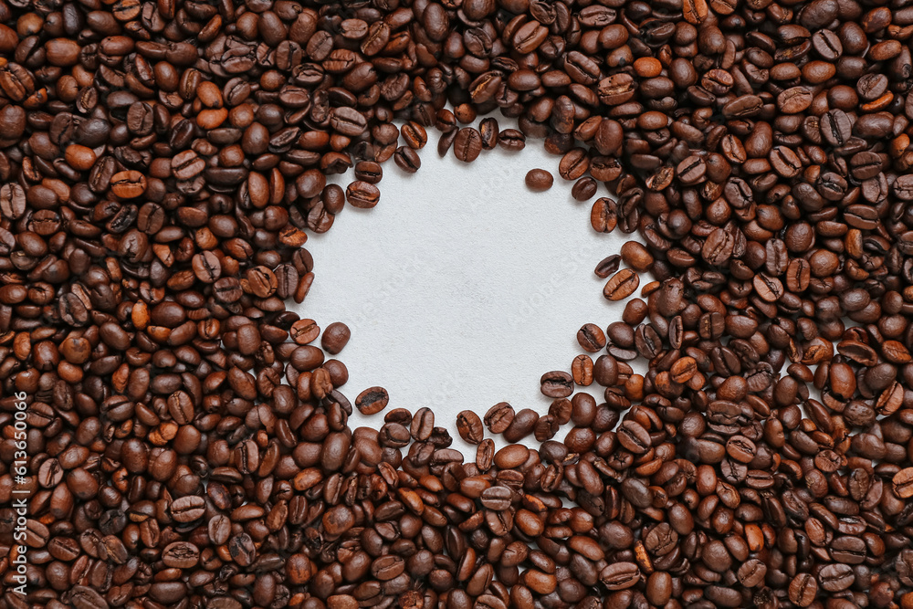 Frame made of coffee beans on light background