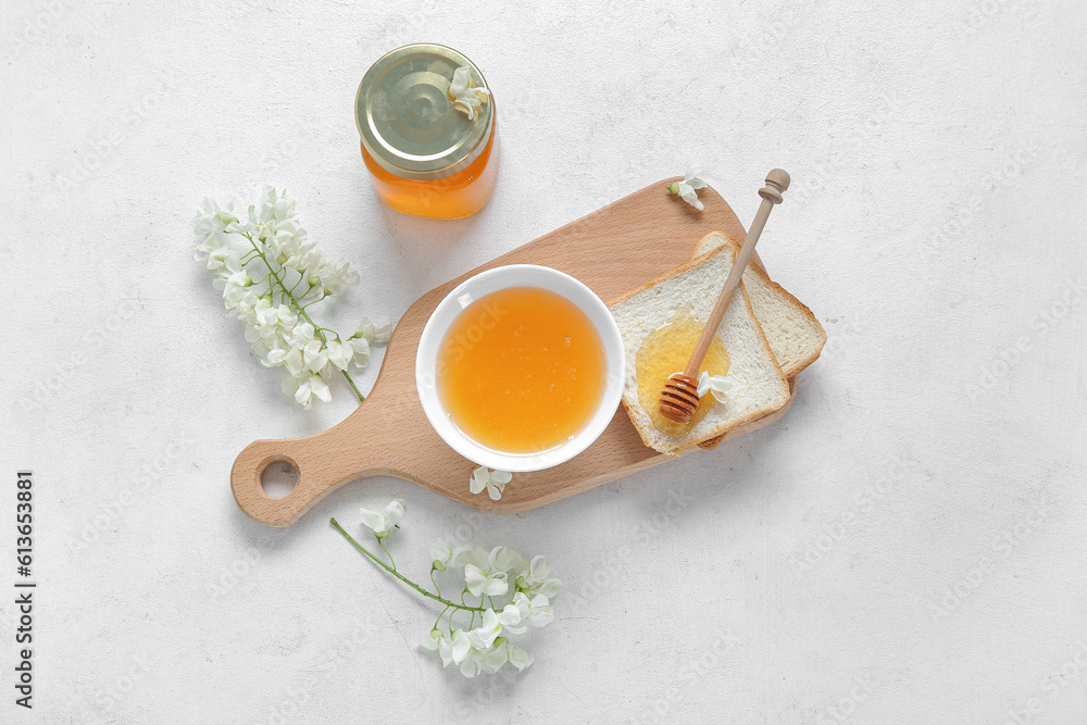 Composition with sweet honey, acacia flowers and dipper on light background