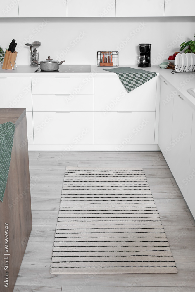 Stylish striped carpet in interior of modern kitchen