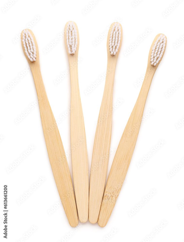 Many bamboo toothbrushes on white background