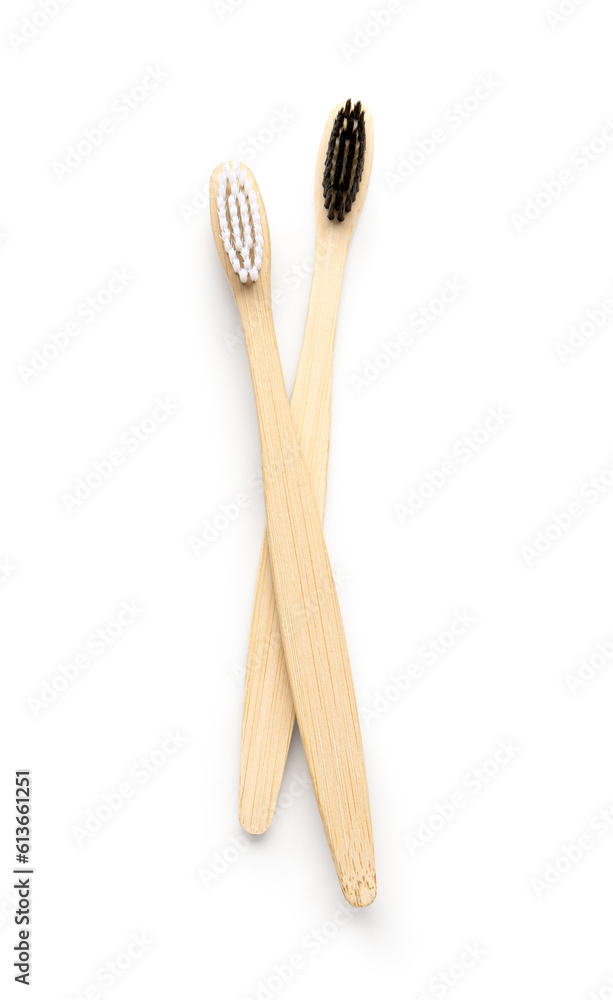 Different bamboo toothbrushes on white background