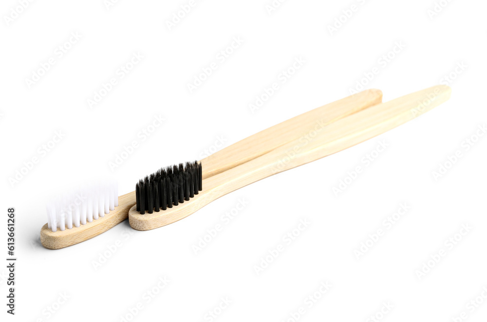 Different bamboo toothbrushes on white background