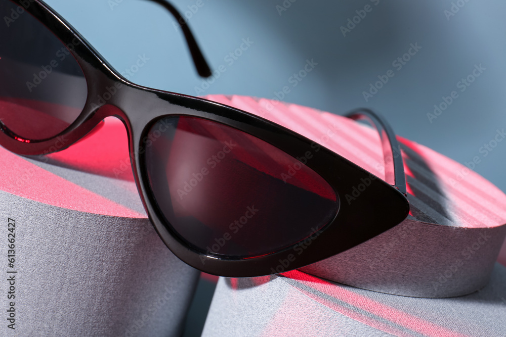 Podiums with stylish sunglasses, closeup