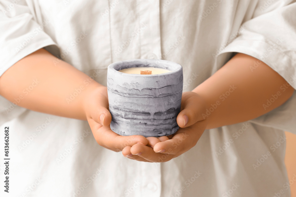 Young woman holding candle, closeup