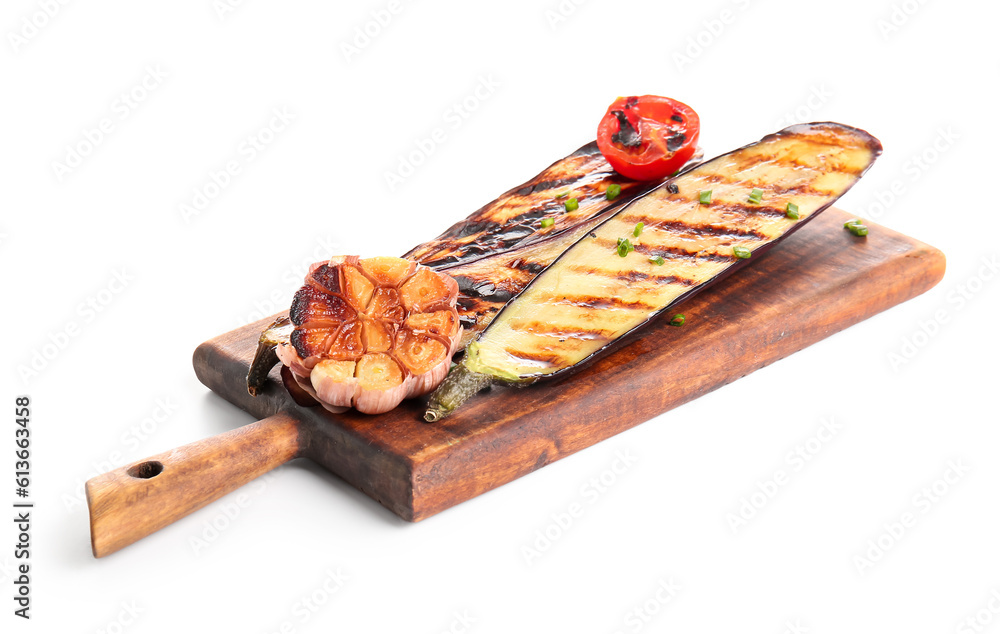 Board with delicious grilled eggplants, garlic and tomato on white background