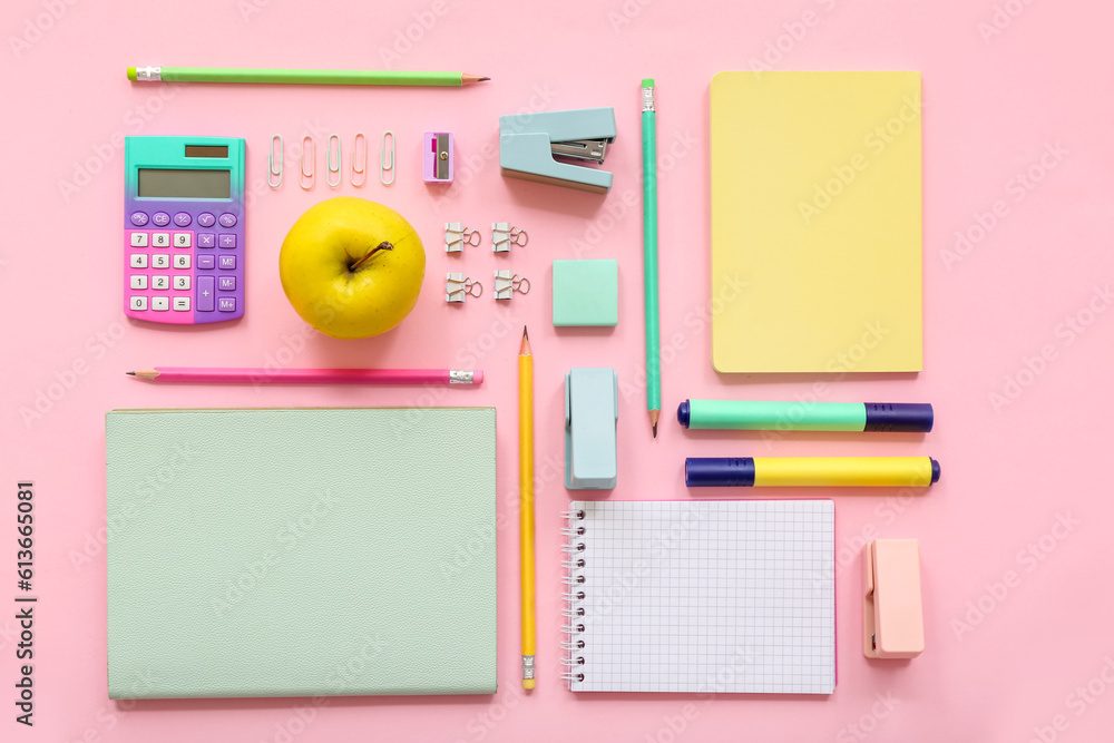 Fresh apple with calculator and different stationery on pink background