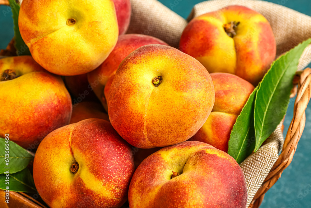 Wicker basket with sweet peaches, closeup