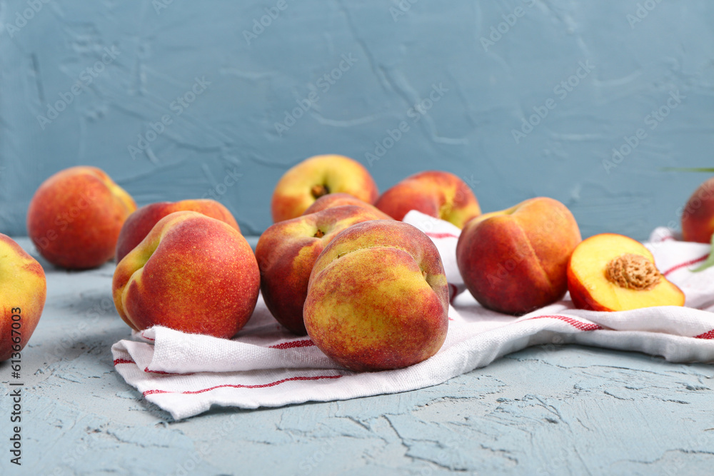 Many sweet peaches on blue background