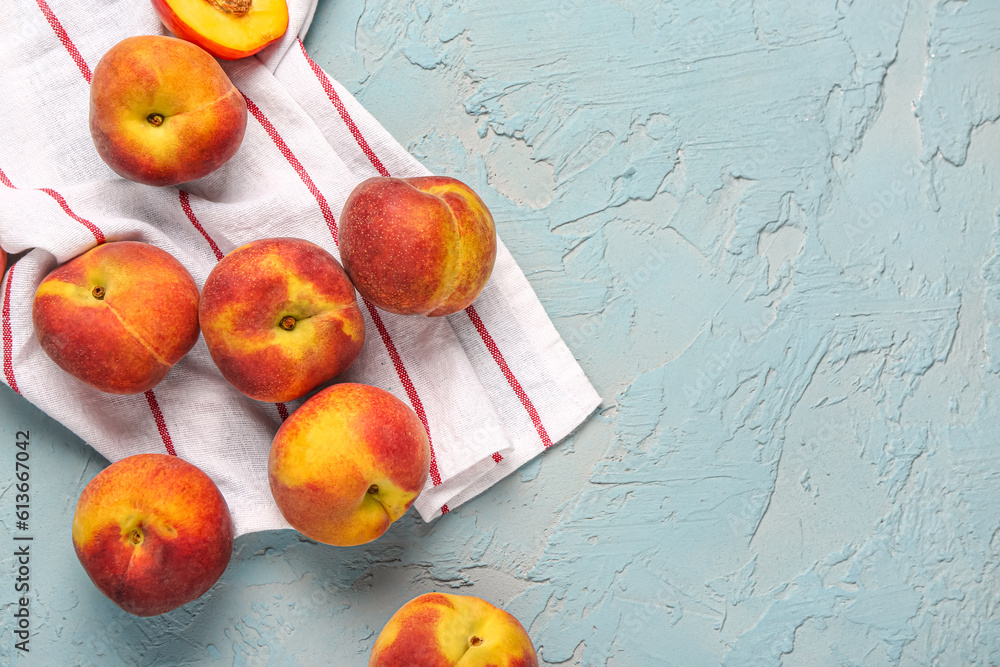 Many sweet peaches on blue background