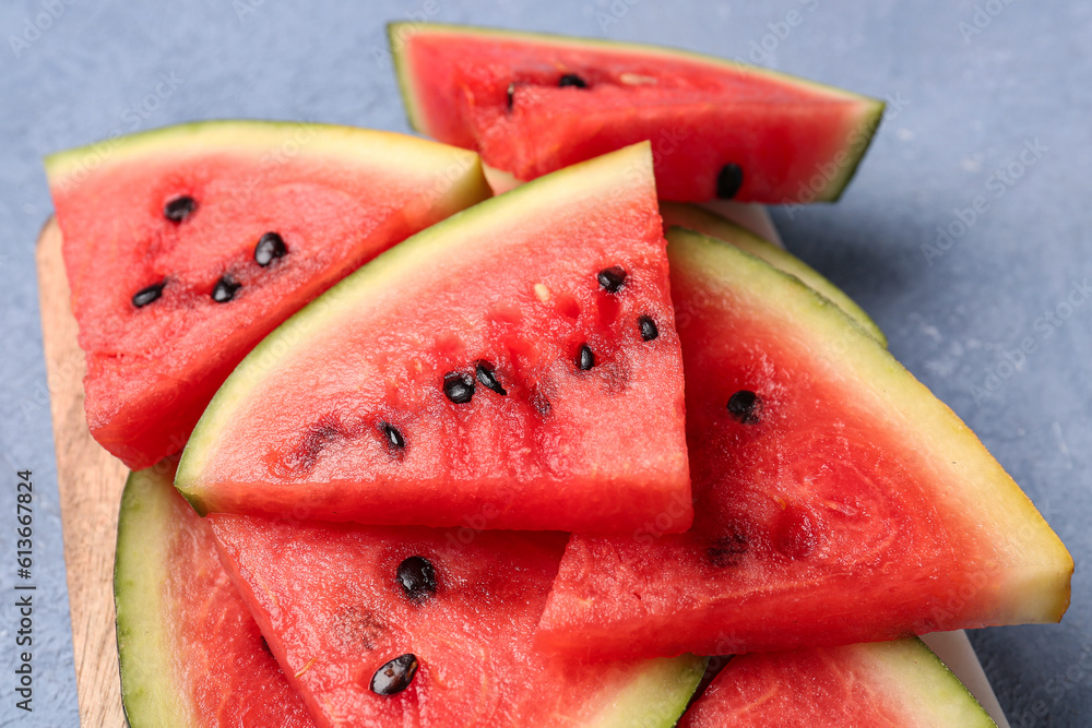 Pieces of fresh watermelon on blue background