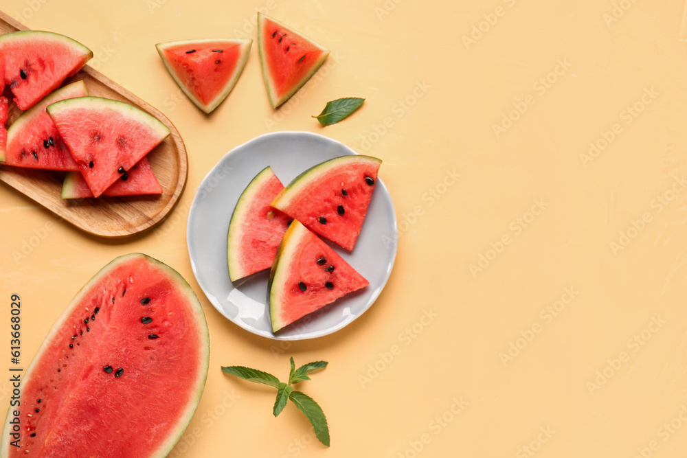 Plate and board with pieces of fresh watermelon on yellow background