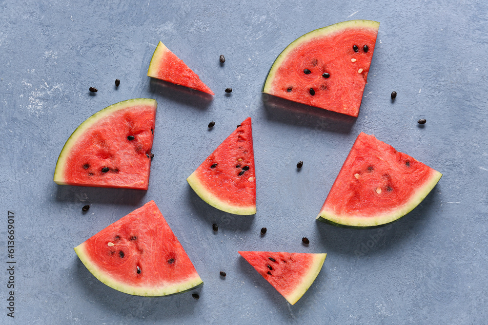 Pieces of fresh watermelon on blue background