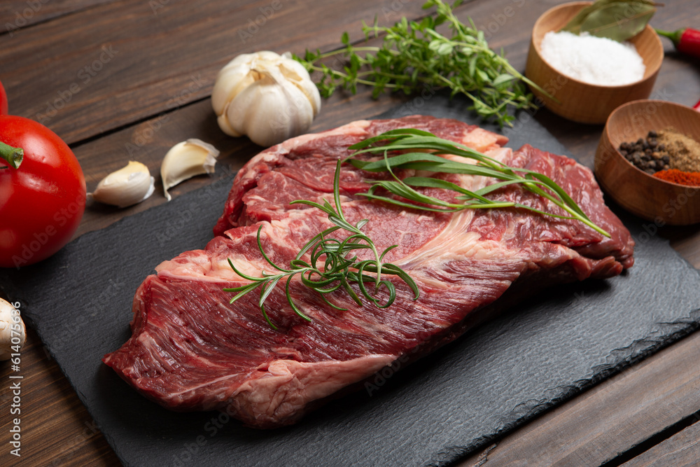 Raw beef steak on wooden table top. Healthy food concept. beef cut and spices for cooking bbq sauce