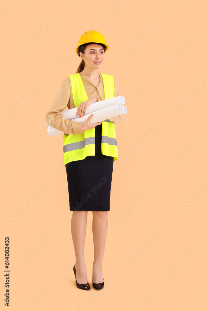 Female architect in vest and with drawings on beige background