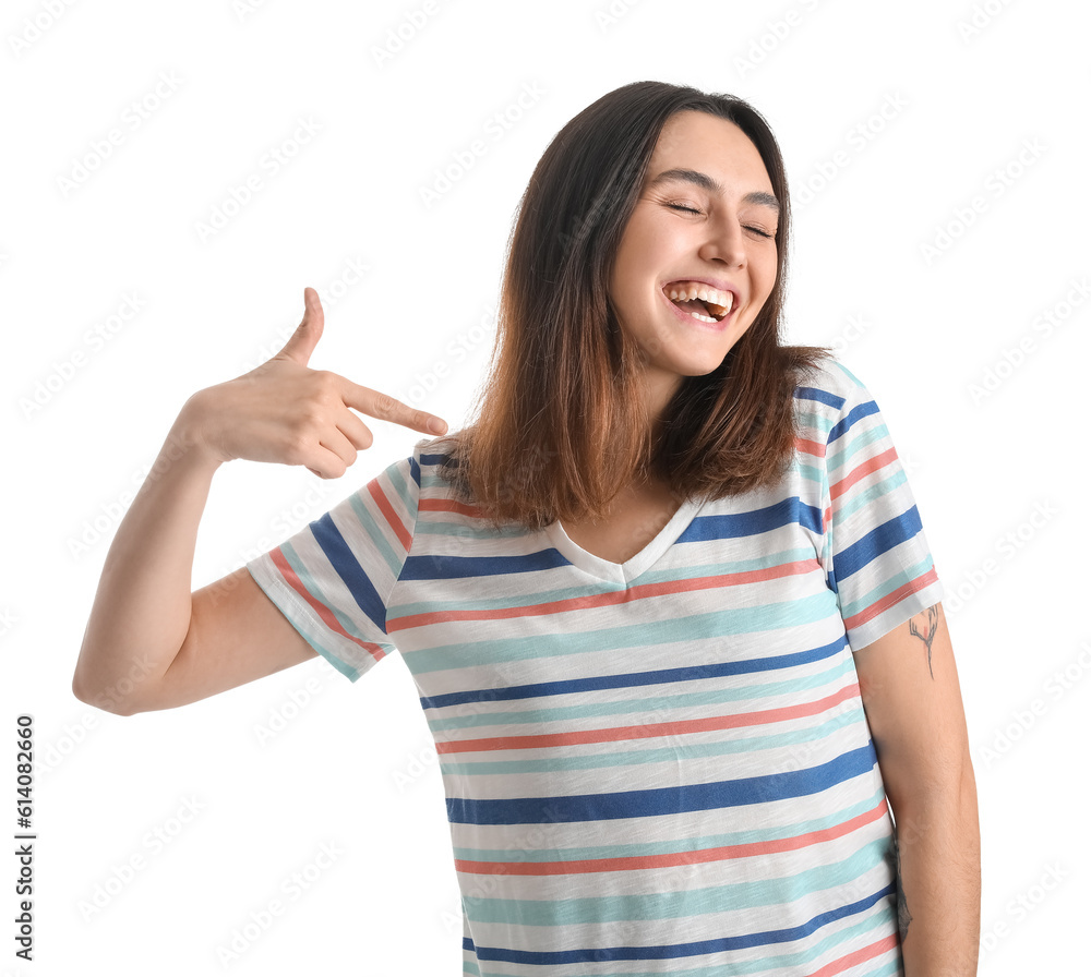 Happy young woman pointing at her t-shirt on white background