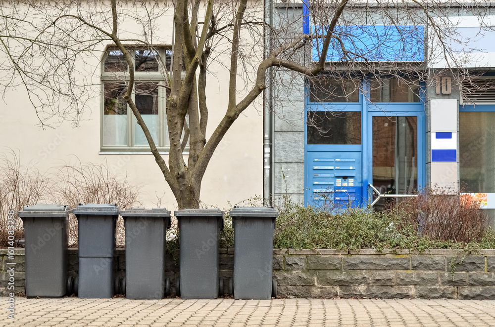 View of city street with garbage containers