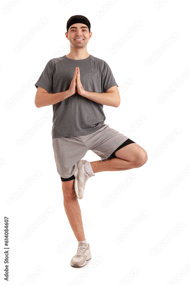 Sporty young man meditating on white background. Balance concept