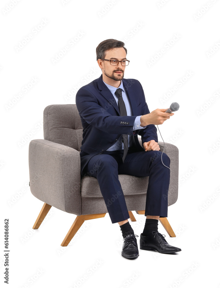 Male journalist with microphone in armchair on white background