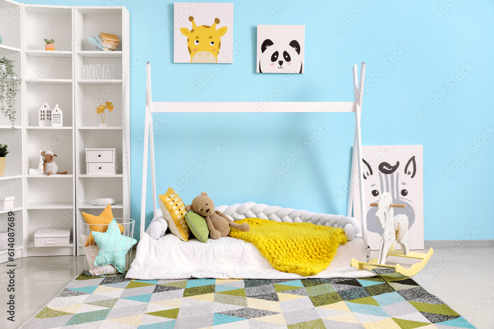 Interior of childrens room with bed, shelving unit and toys