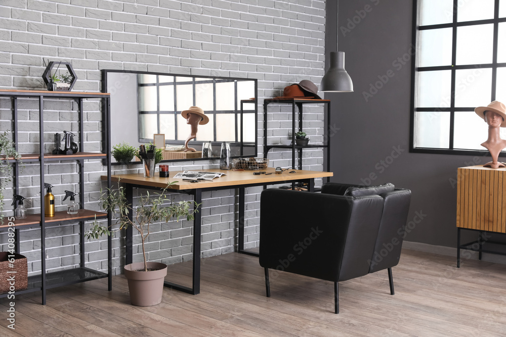 Interior of beauty salon with comfortable armchair, table and mirror