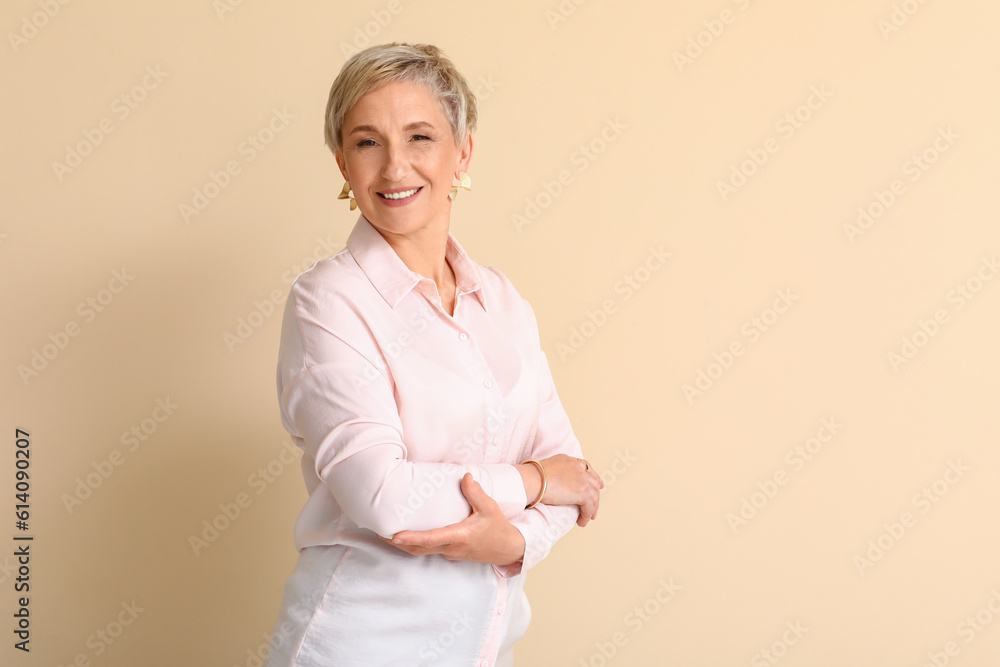 Mature blonde woman on beige background